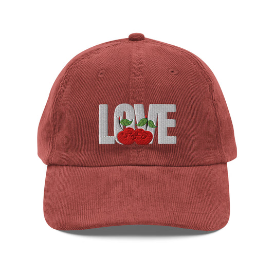 Red cap with 'LOVE' and cherry design on a white background