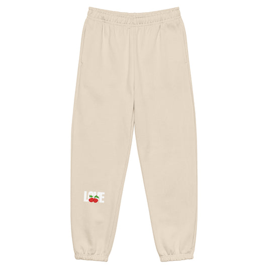 Beige sweatpants with a logo on a white background